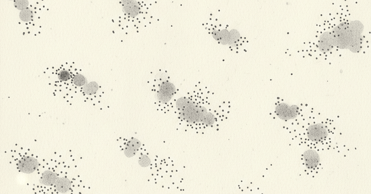 Clusters of ink dots spreading across paper